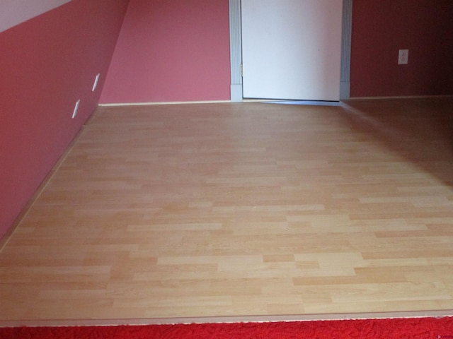 empty room with light hardwood / wood-style flooring