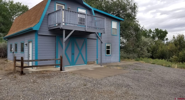 back of house featuring a balcony