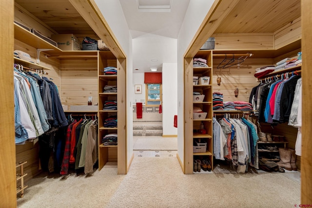 spacious closet featuring light colored carpet