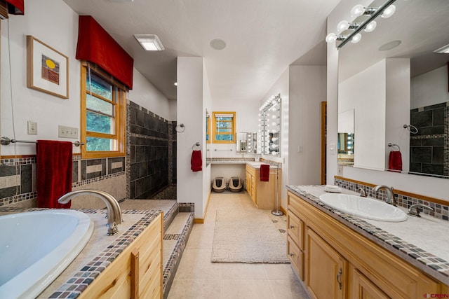 bathroom featuring vanity, tile patterned floors, and separate shower and tub