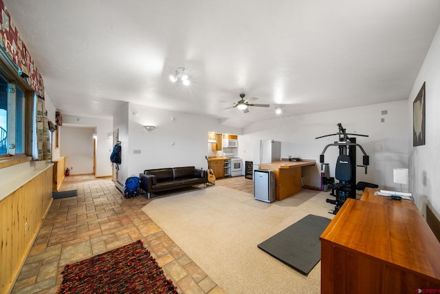 interior space with ceiling fan