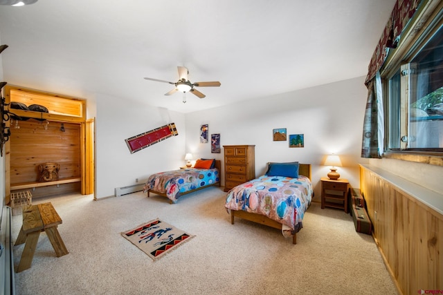 bedroom with light carpet, baseboard heating, and ceiling fan