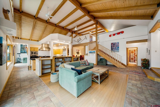 living room with vaulted ceiling with beams, light tile patterned floors, and ceiling fan