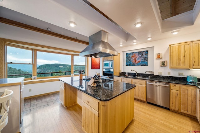 kitchen with island exhaust hood, a center island, a wealth of natural light, and appliances with stainless steel finishes