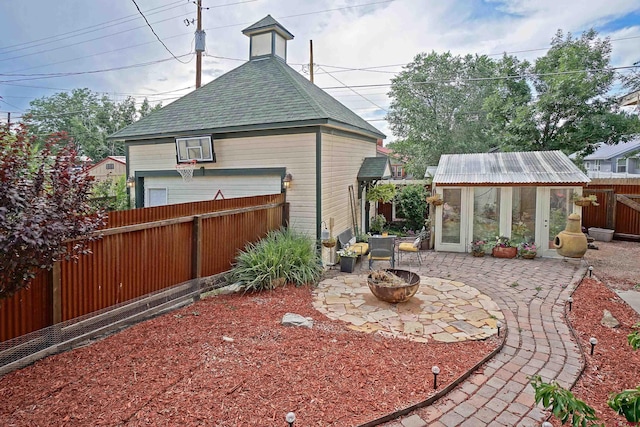 view of patio featuring an outbuilding and an outdoor fire pit