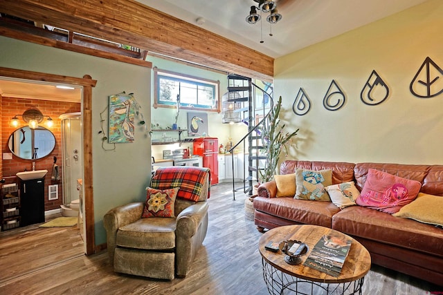 living room featuring brick wall and wood-type flooring