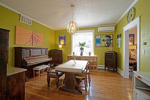 dining space with a baseboard heating unit, ornamental molding, a notable chandelier, light hardwood / wood-style flooring, and a wall mounted air conditioner