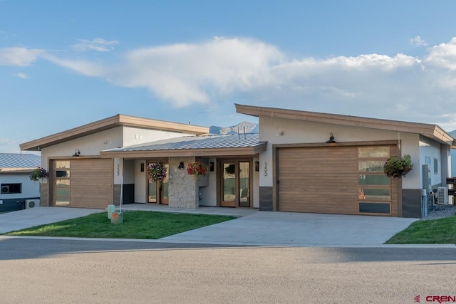 modern home featuring a garage and central AC