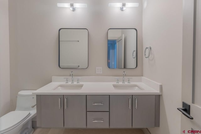 bathroom featuring vanity and toilet