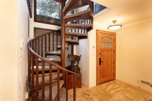 staircase featuring light tile patterned flooring