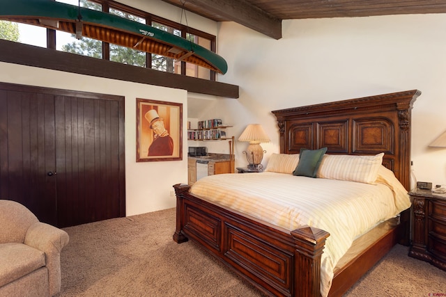 carpeted bedroom featuring beamed ceiling, wooden ceiling, and high vaulted ceiling