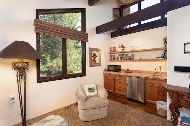 interior space with beam ceiling, dark hardwood / wood-style flooring, and sink