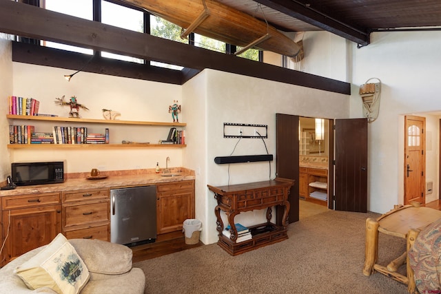 living room featuring wood-type flooring, wooden ceiling, high vaulted ceiling, beamed ceiling, and sink