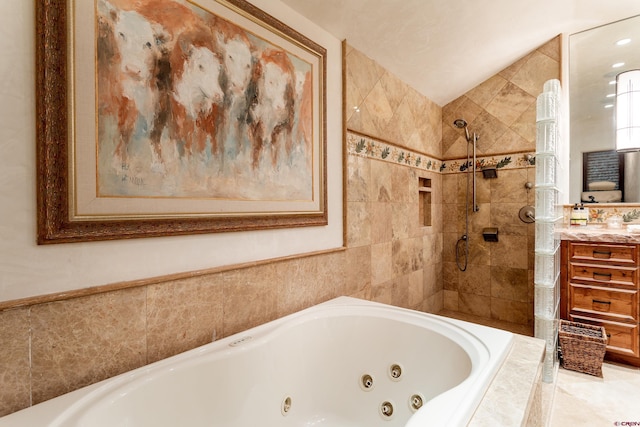 bathroom featuring vanity, a tile shower, and vaulted ceiling