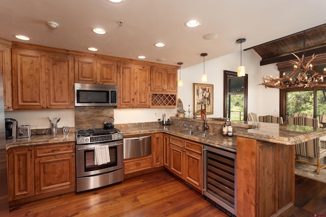 kitchen featuring dark hardwood / wood-style floors, stainless steel appliances, kitchen peninsula, and wine cooler