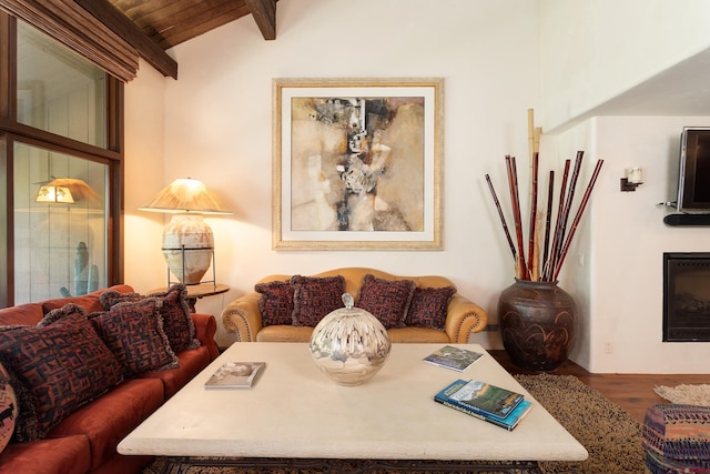 dining room featuring lofted ceiling with beams and hardwood / wood-style flooring