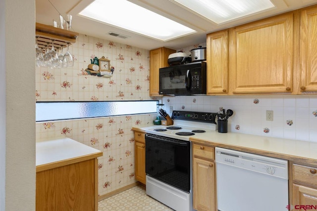 kitchen featuring backsplash, light brown cabinetry, white appliances, and light tile patterned floors