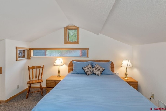 carpeted bedroom with lofted ceiling