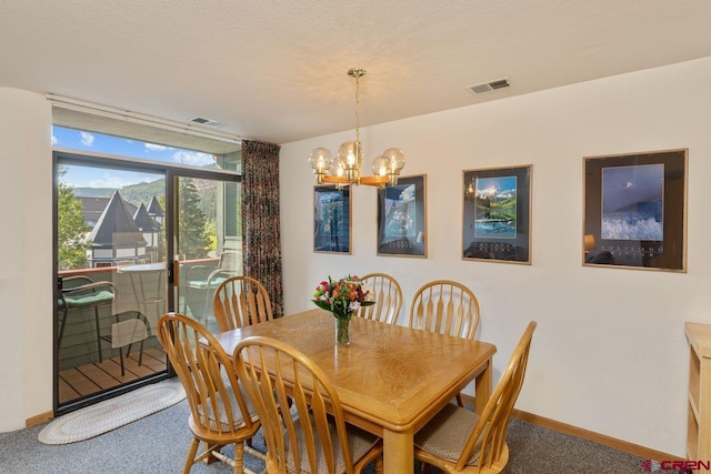 dining space with an inviting chandelier and carpet floors