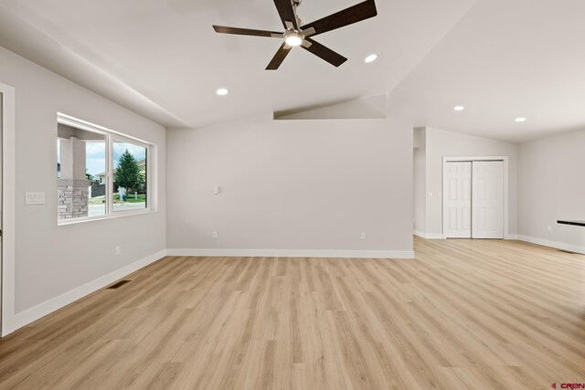 unfurnished room with ceiling fan, light hardwood / wood-style flooring, and vaulted ceiling