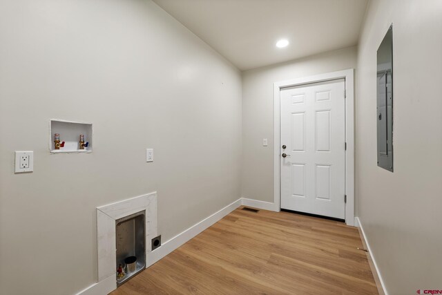 laundry area with hookup for a washing machine, hookup for an electric dryer, and light wood-type flooring