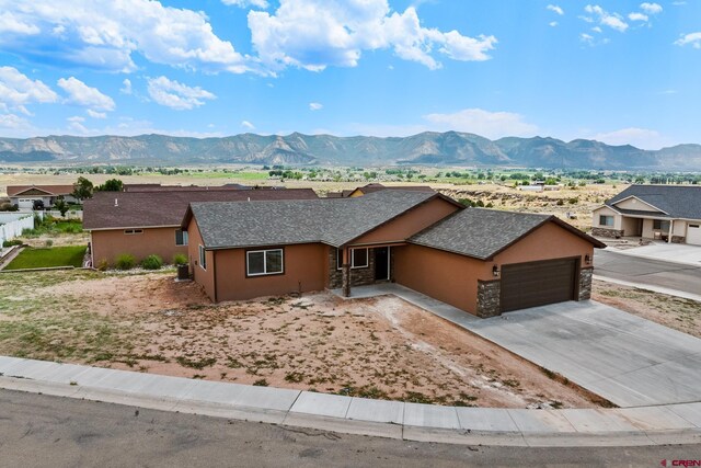 ranch-style house featuring a mountain view and a garage