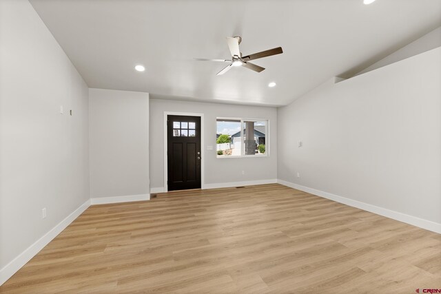 foyer with light hardwood / wood-style floors, lofted ceiling, and ceiling fan