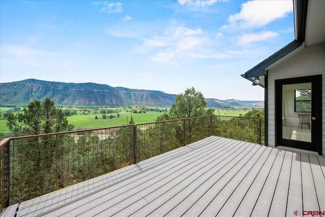 wooden deck featuring a rural view and a mountain view