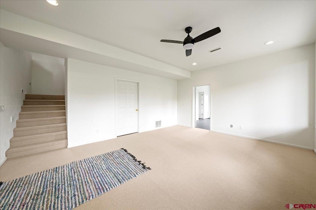 carpeted spare room featuring ceiling fan