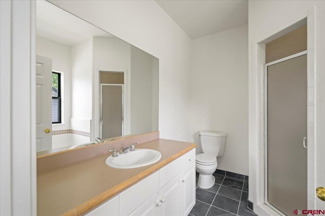 bathroom featuring vanity, toilet, tile patterned flooring, and a shower with door