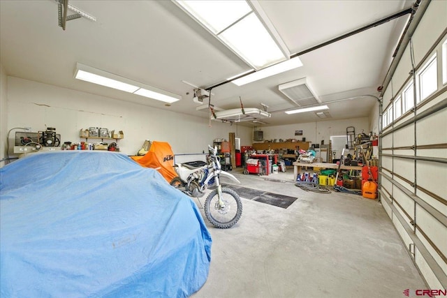 garage featuring a garage door opener and a workshop area