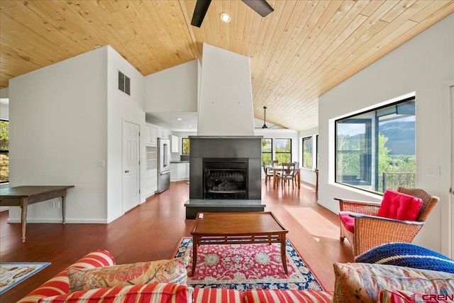 living room featuring a multi sided fireplace, hardwood / wood-style floors, lofted ceiling, ceiling fan, and wood ceiling