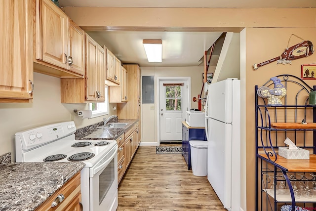 kitchen with dark stone counters, light hardwood / wood-style flooring, white appliances, electric panel, and light brown cabinetry