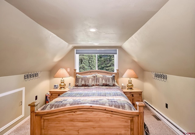 carpeted bedroom with baseboard heating and lofted ceiling