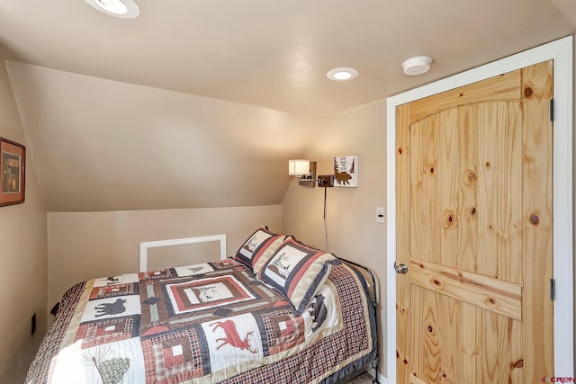 bedroom with lofted ceiling