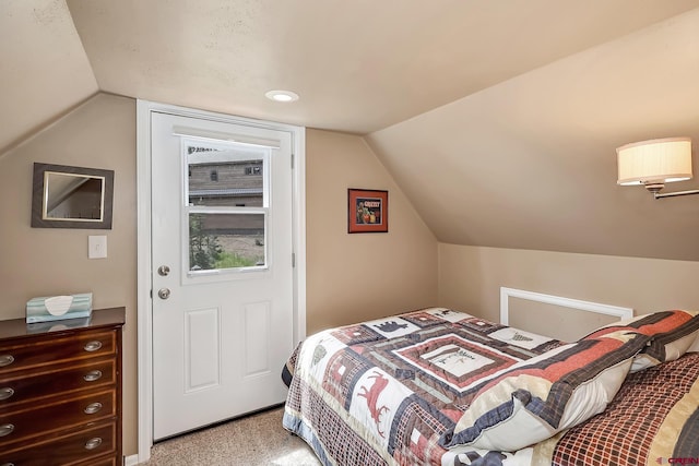 carpeted bedroom with vaulted ceiling