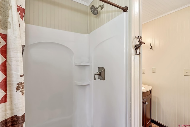 bathroom featuring vanity, a shower with shower curtain, and crown molding