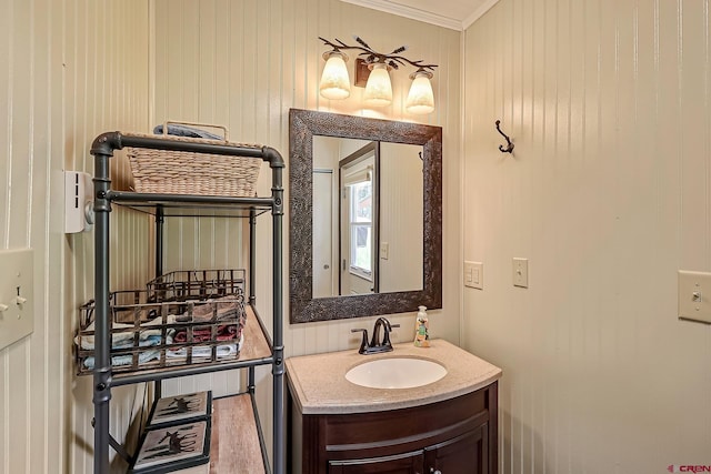 bathroom featuring ornamental molding, vanity, and wood-type flooring