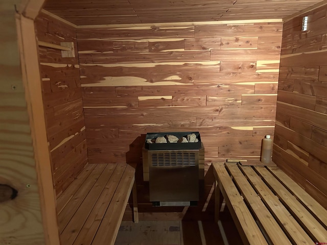 view of sauna featuring wooden walls and wooden ceiling