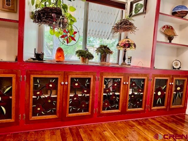 bar with hardwood / wood-style flooring and a wealth of natural light