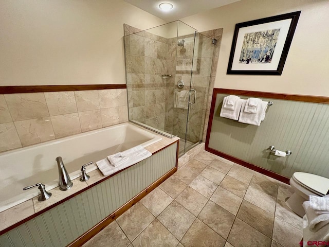 bathroom featuring independent shower and bath, tile patterned floors, and toilet