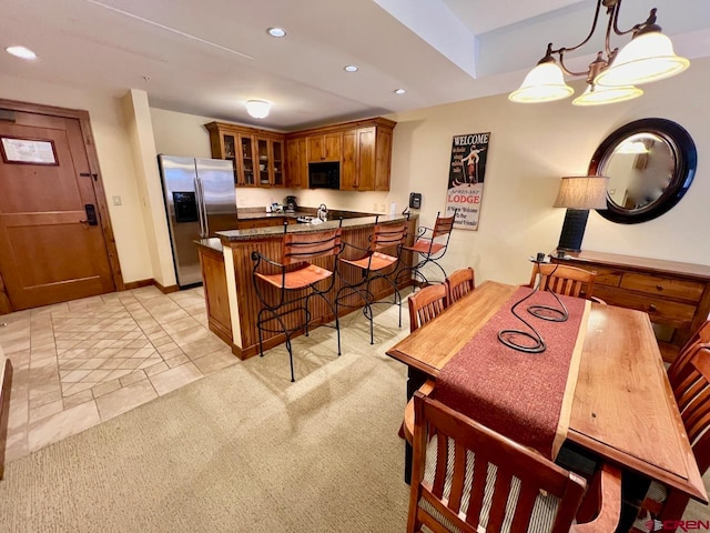 tiled dining room featuring a notable chandelier