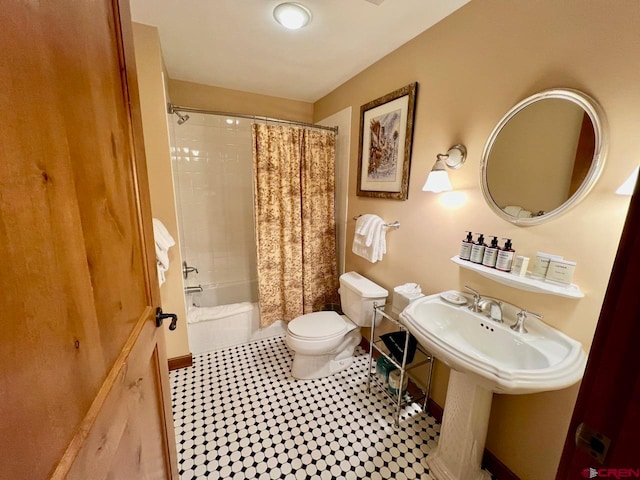 bathroom featuring shower / bathtub combination with curtain, tile patterned floors, and toilet