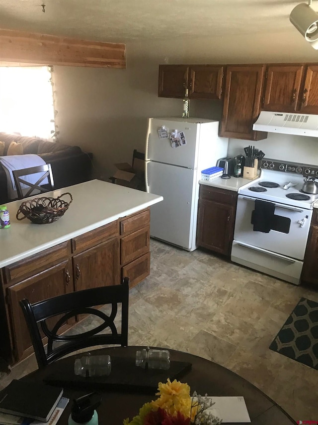 kitchen with light tile patterned flooring and white appliances