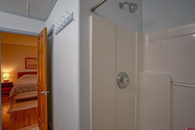 bathroom with wood-type flooring and walk in shower