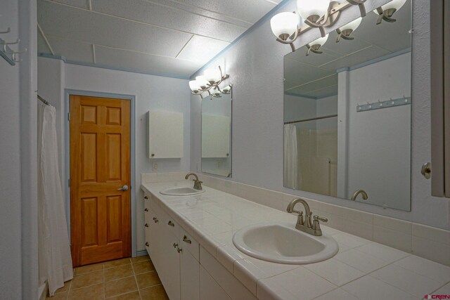 bathroom with double vanity and tile patterned floors