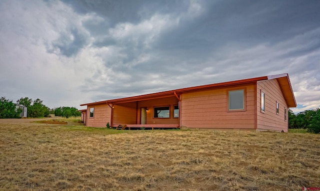 back of house with a lawn