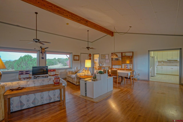 living room featuring light hardwood / wood-style floors, high vaulted ceiling, and ceiling fan