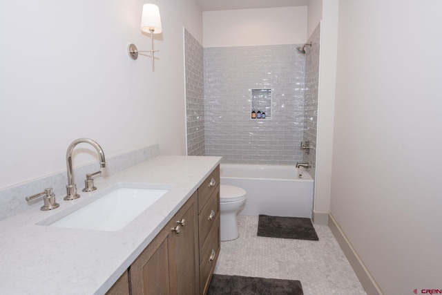 full bathroom with tile patterned floors, vanity, tiled shower / bath combo, and toilet