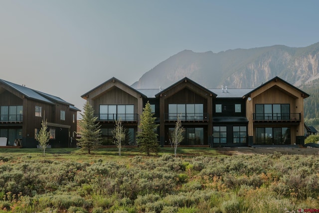 rear view of house featuring a mountain view